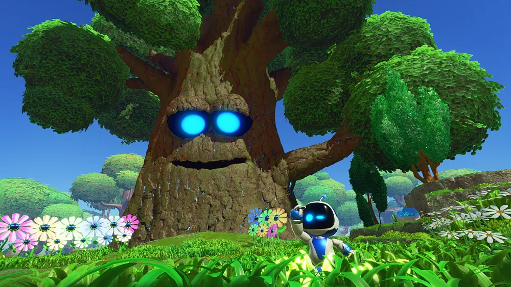Astro Bot, a little adorable robot guy, running through a grassy field with flowers as a big tree with a friendly face can be seen in the background.
