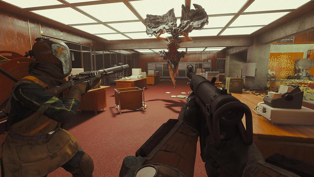 A couple of teammates with automatic weapons aiming at a flying paranatural foe in an office space.
