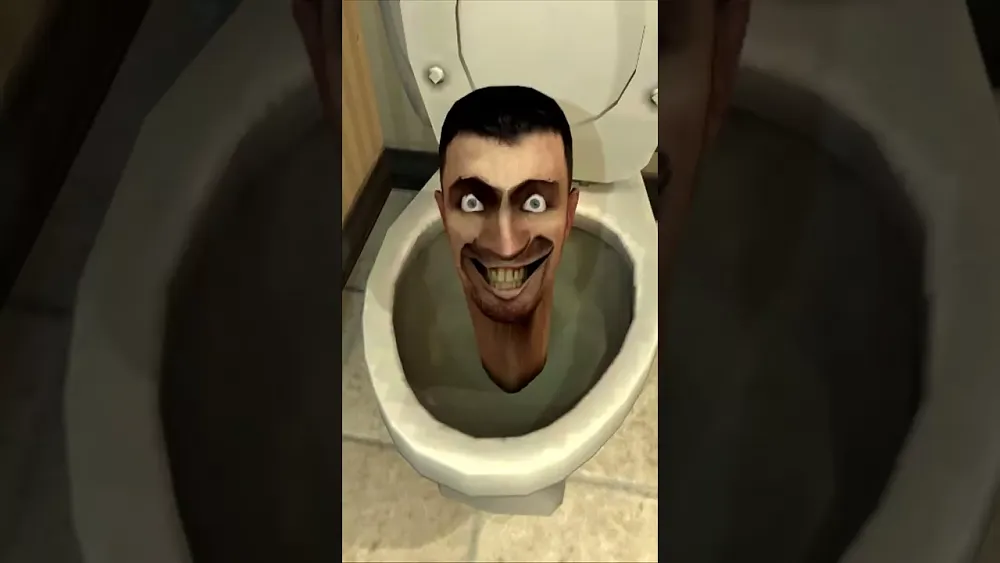 A man's head coming out of a toilet.