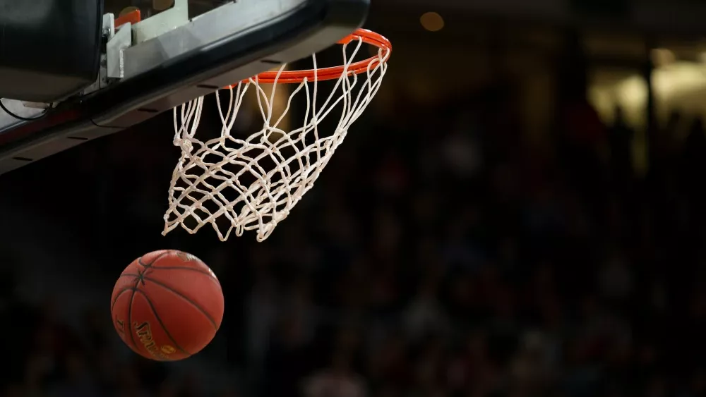 A basketball after it was shot through a hoop.