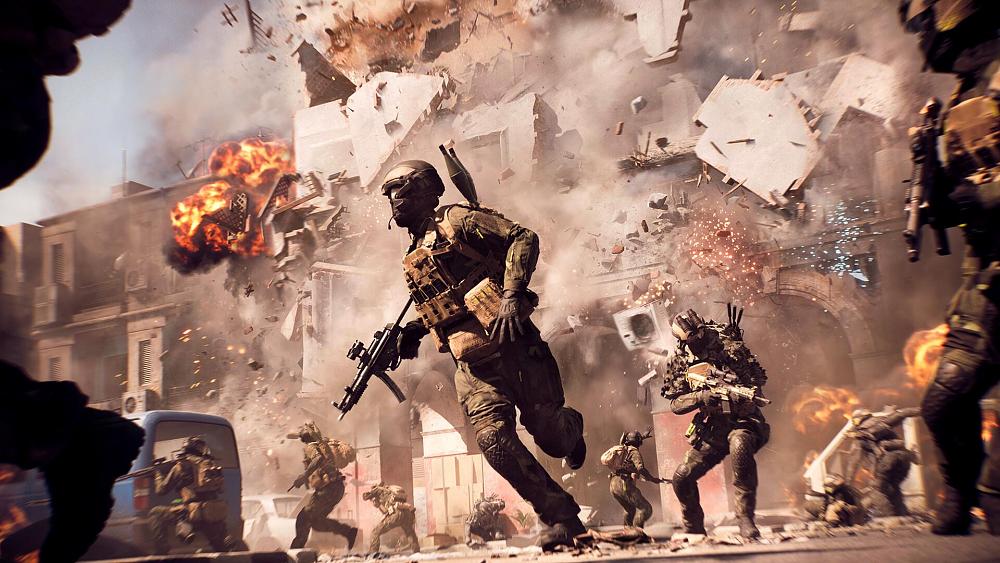 Soldiers run from a crumbling building that was hit with an explosion.