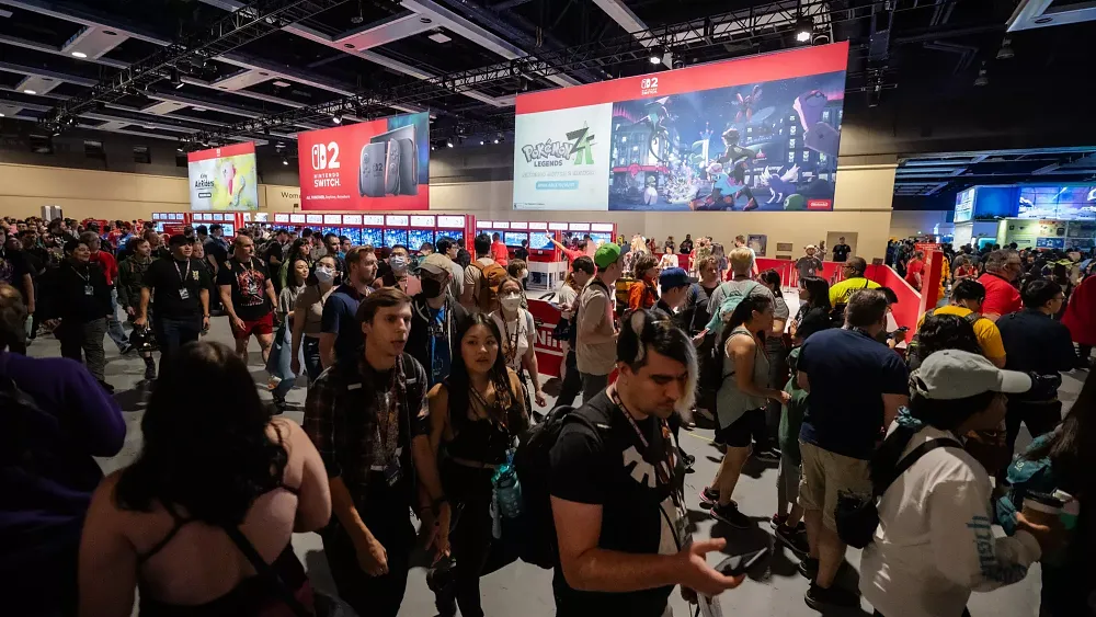 A photograph of a huge group of people attending PAX West 2025 in a big convention hall.