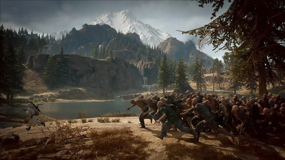 A man being chased by a huge horde of zombies in a forested area by a lake.