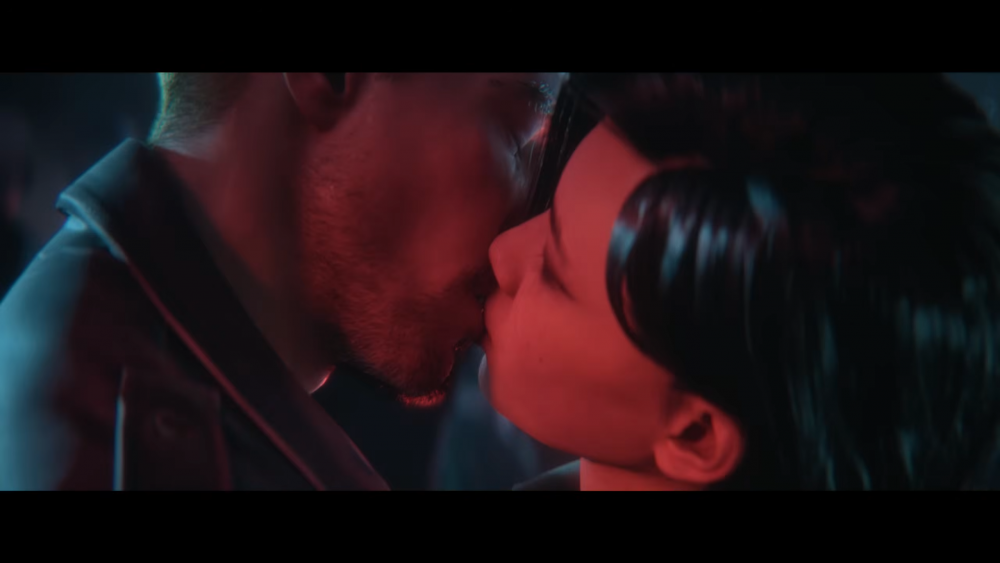 A still from the new love story trailer for Clive Barker's Hellraiser: Revival showing a couple kissing.