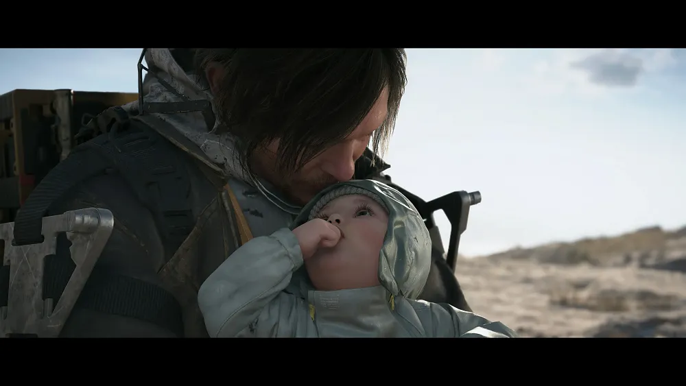 A man kissing a baby on the forehead in a scene from Death Stranding 2.