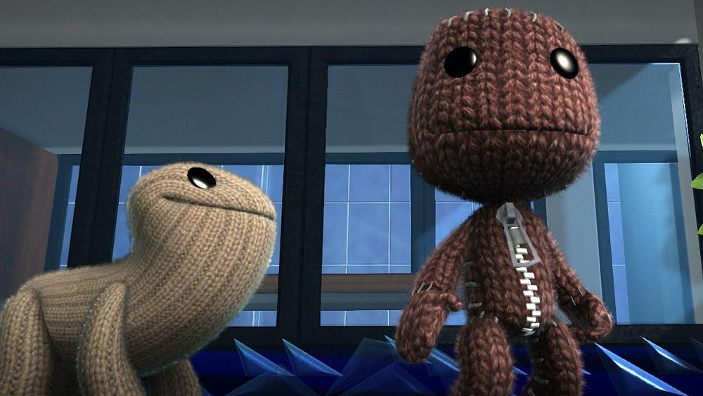 Puppets made out of cloth. The one on the left looks kind of like an earless dog. The one on the right is kind of human-like with a big head.