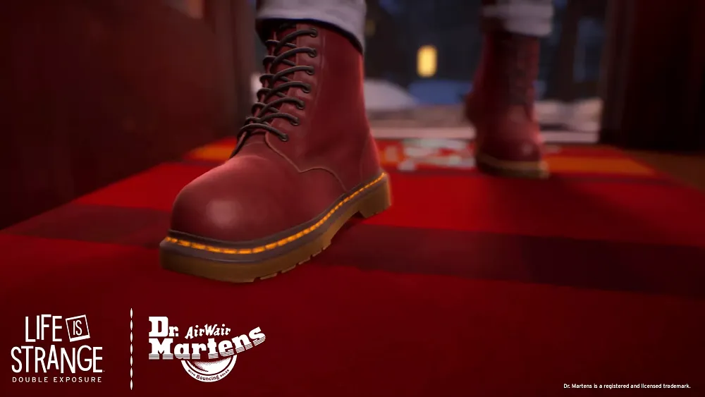 A closeup of a young woman walking on a red carpet in a pair of Dr. Marten leather cherry red boots.