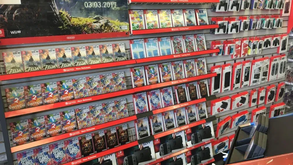 Photo showing a variety of physical game boxes for various Nintendo Switch titles on display in a store.