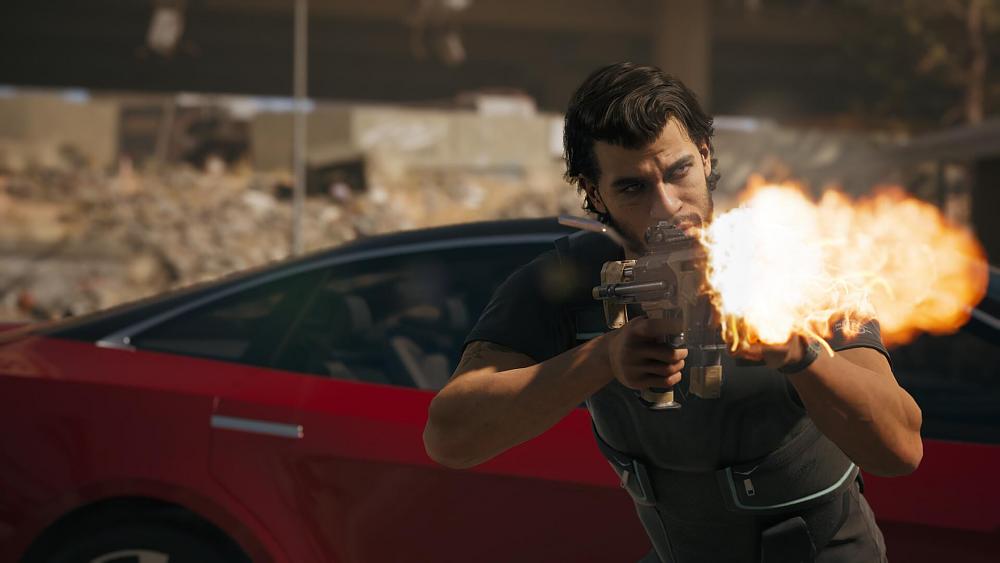 A man some black tactical clothing firing an assault rifle.