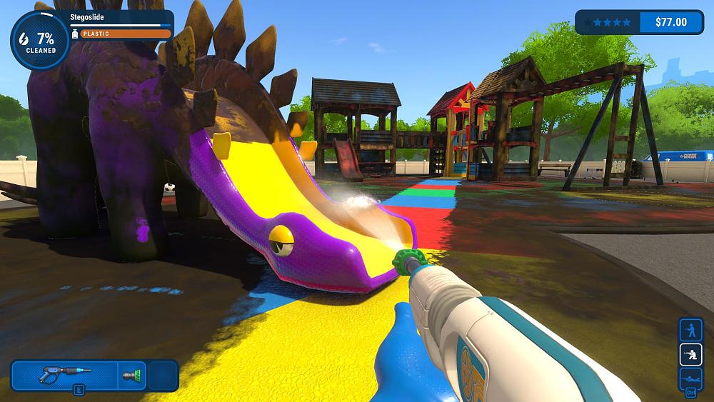 A power washing tool is being used to clean a purple dinosaur slide at a children's outdoor play area. The ground is a multi-colored rubber map. There are monkey bars, short towers, and another slide seen in the background.