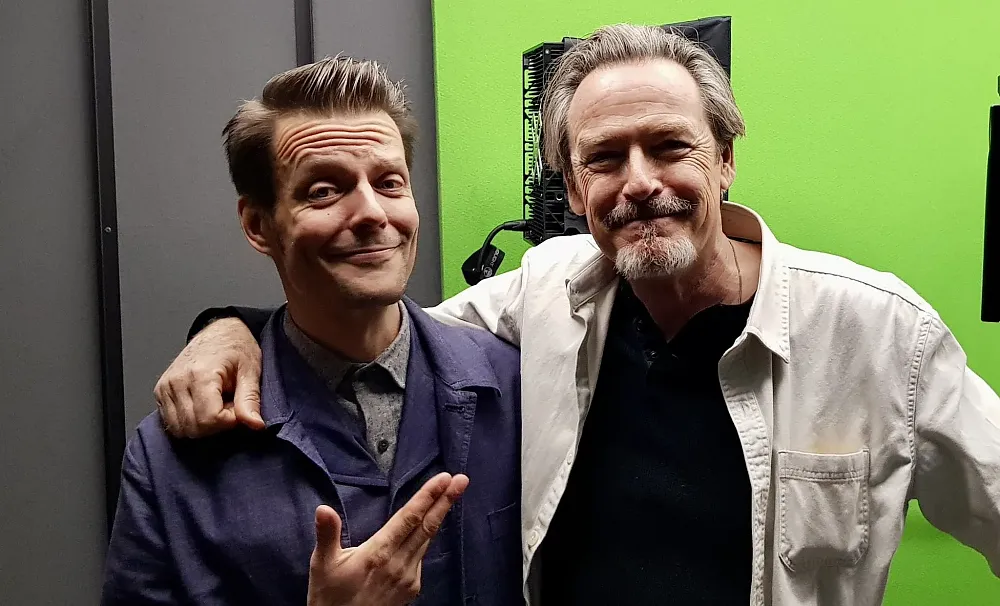 Two men smiling at the camera. On the left is Sam Lake from Remedy Entertainment. On the right is James McCaffrey, the voice of Max Payne and Alex Casey