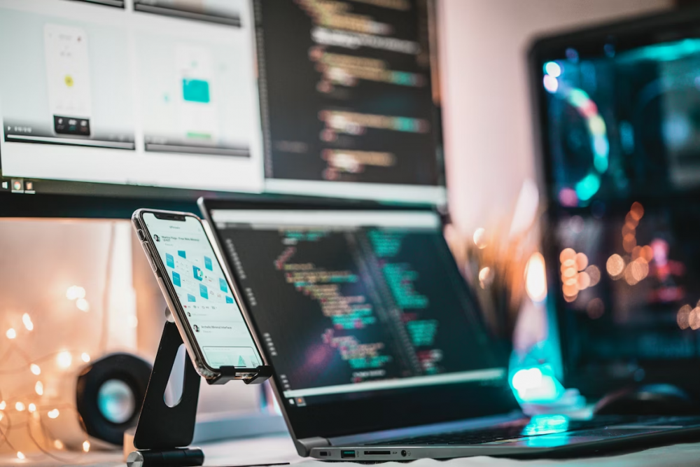 Computer monitors and mobile devices all arranged on a desk