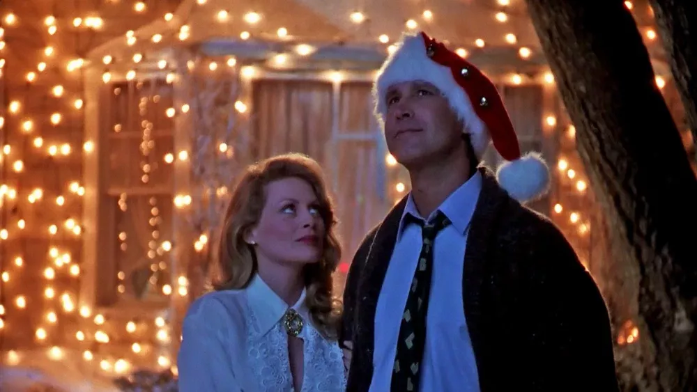 A woman and man outside looking at Christmas lights. A still from National Lampoon's Christmas Vacation.