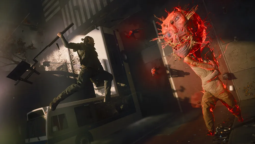 Guy with a manbun and a large hammer type weapon doing a leaping attack at a red glowing enemy that looks like a walking lightbulb.