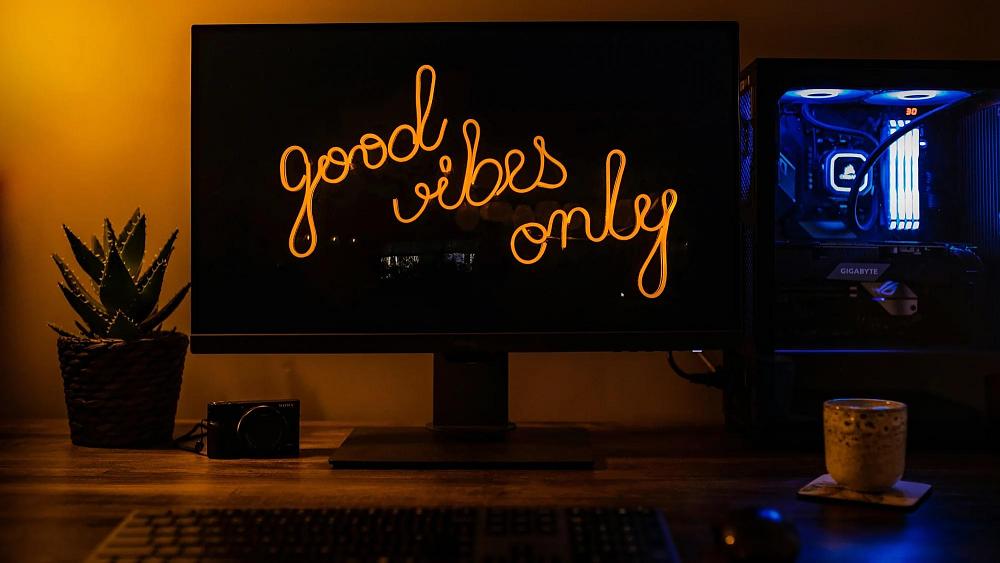 A desktop PC with a background that says Good Vibes Only. Photo from Andy Holmes on unsplash.