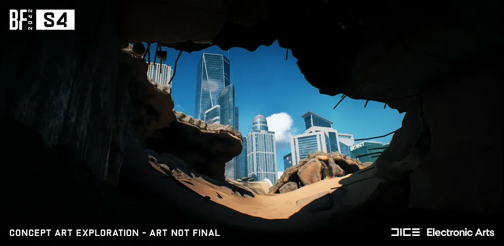 Looking out from a partially destroyed tunnel. In front is sand and rocky outcroppings. In the background are skyscapers in a city.
