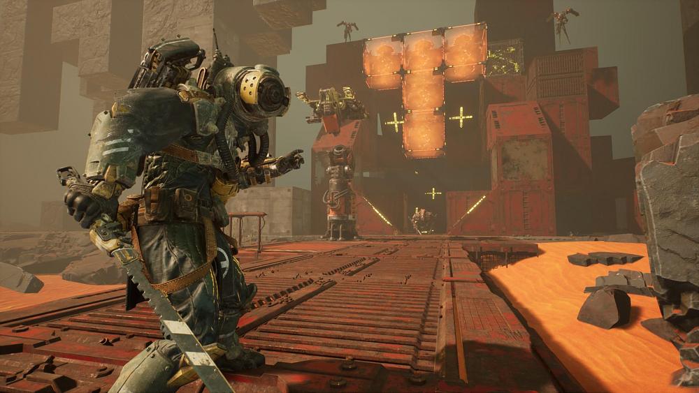 Person in a cobbled together protection suit holding a serrated sword stands in front of a base made out of red metalic parts and created by another player.