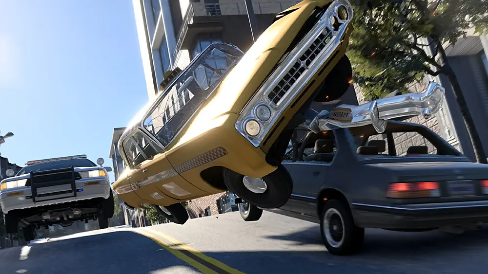 A taxi cab ramping off an oncoming car as a police car gives chase.