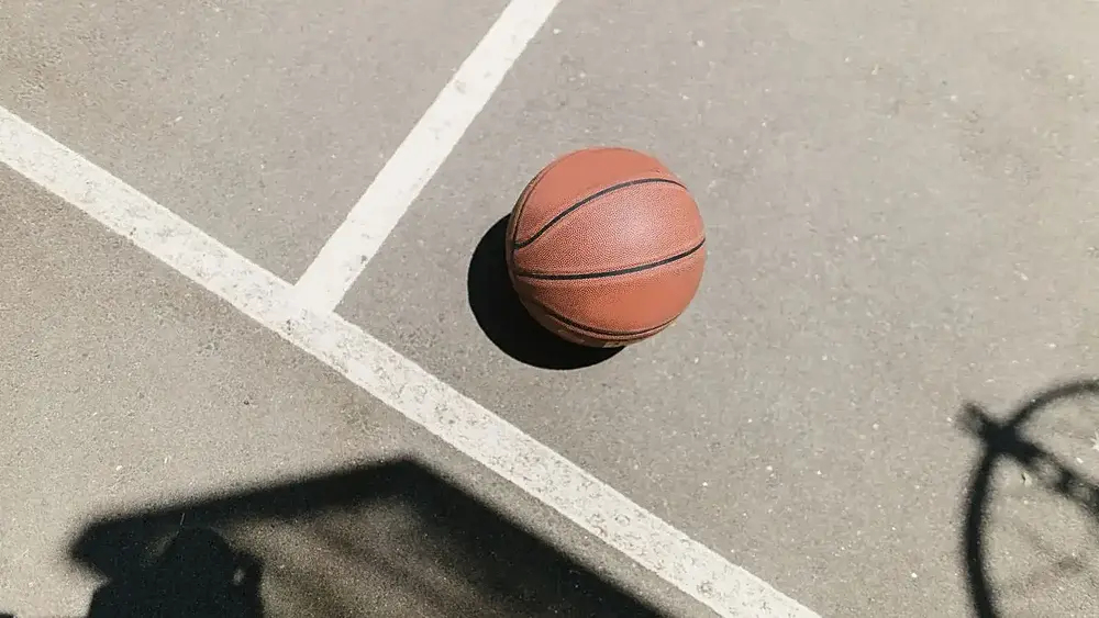 A basketball on a basketball court. Image via: images.pexels.com