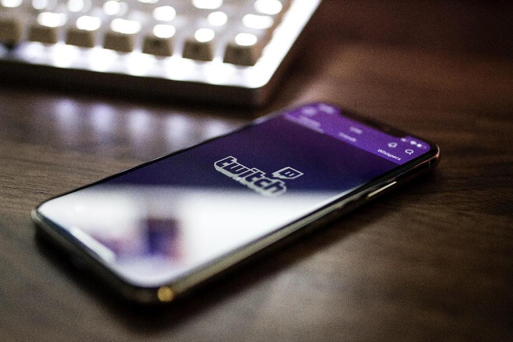 picture of a phone sitting on a desk with the Twitch app running
