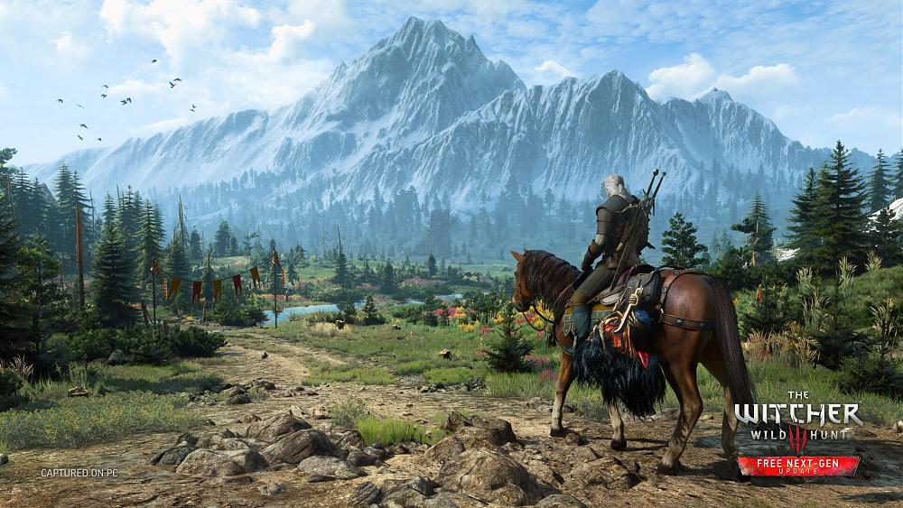Screenshot showing Geralt riding a horse in a lush green valley as snow covered mountain loom in the distance
