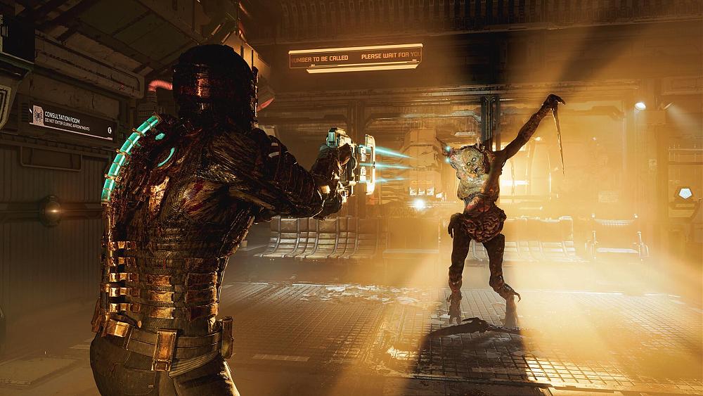 Screenshot showing a man in an armored space suit aiming a weapon at an alien. The alien has long pointed arms and is grossly disfigured. The two are inside a metallic room lit from the back in orange lighting.