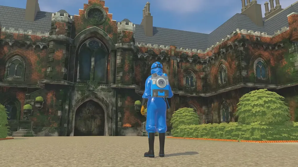 A person in a full body blue plastic suit has a power washer attached to their back. They stand in a driveway and are facing a very dirty, very large mansion.
