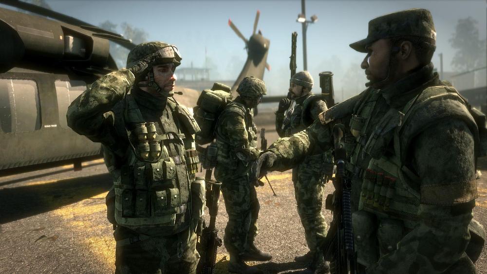 Soldiers saluting and talking to one another while standing near a helicopter.
