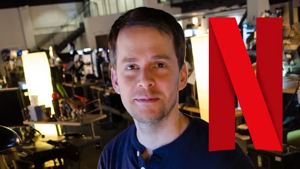 Photo of a man in a blue shirt looking at the camera. The big red N Netflix logo is to the right in the image.