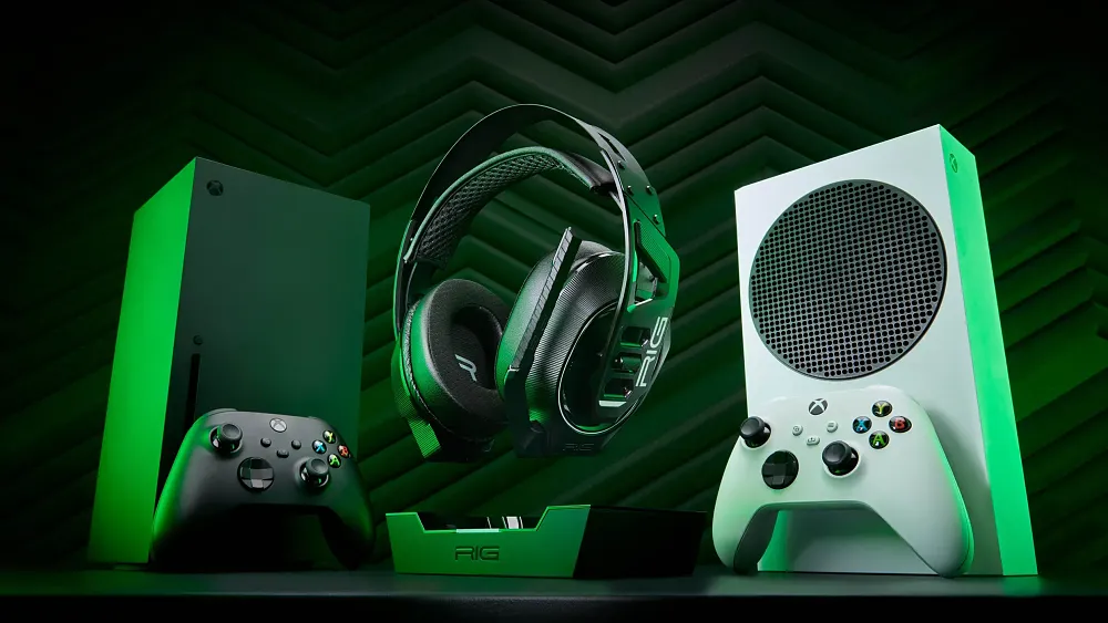 Wireless headphones in front of two Xbox consoles