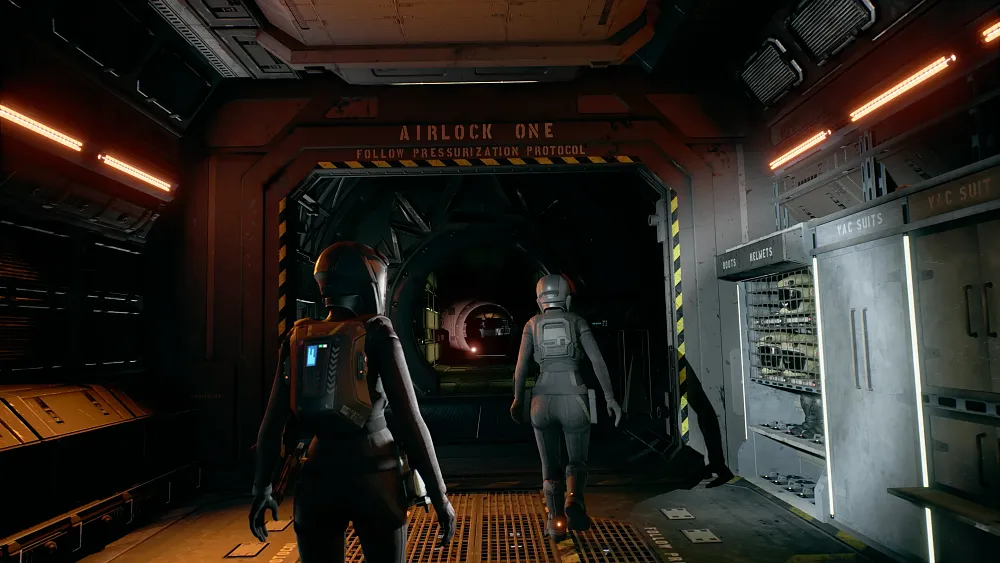 Two soldiers walking down a dark hallway of a space ship.