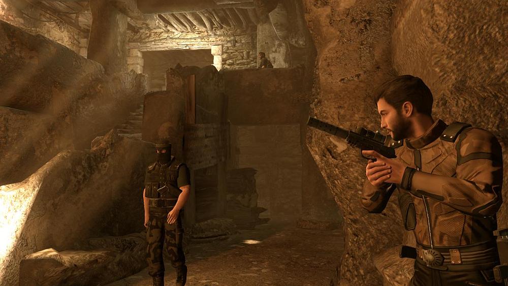 A spy with a silenced weapon taking cover from an enemy inside a cave.