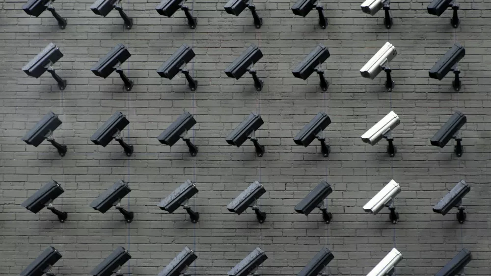 Photo of security cameras on a wall from https://unsplash.com/photos/assorted-color-security-cameras-LfaN1gswV5c