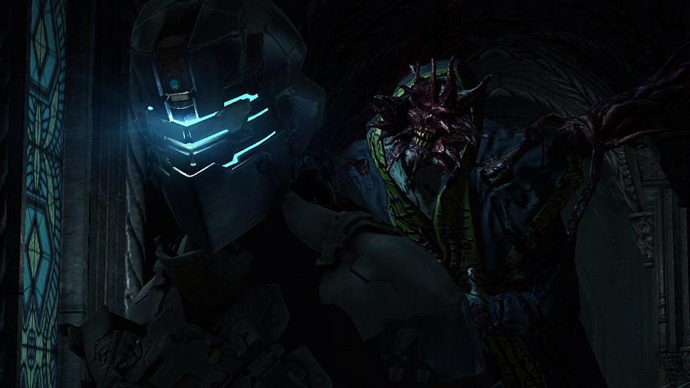 A screenshot from Dead Space 2 with Isaac Clark in the foreground an a mutated creature with a split open face approaching from behind.