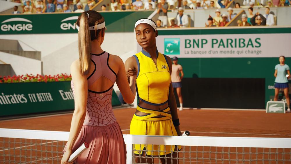 Two pro tennis athletes shaking hands across the net.